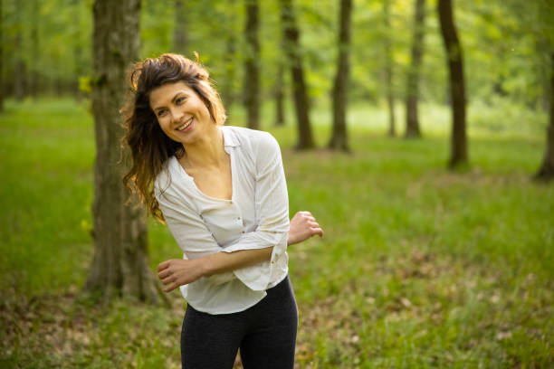 istock Young woman having fun in forest 1354078558