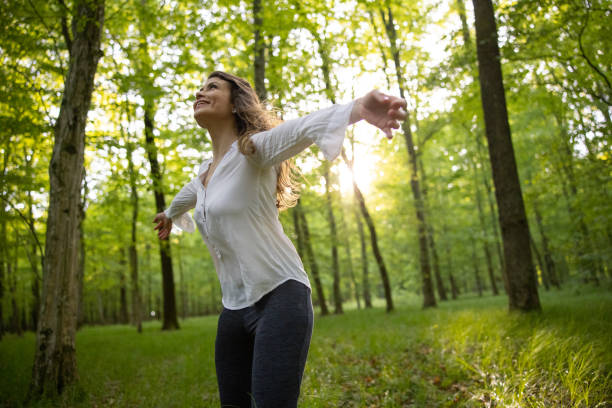 istock Beautiful woman enjoying in forest 1354078596