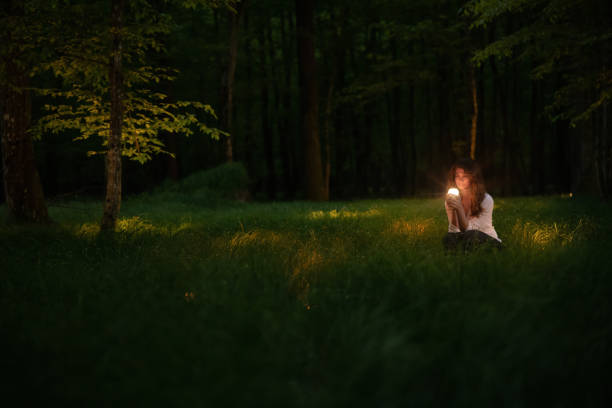 istock Young woman holding glowing object 1354079016