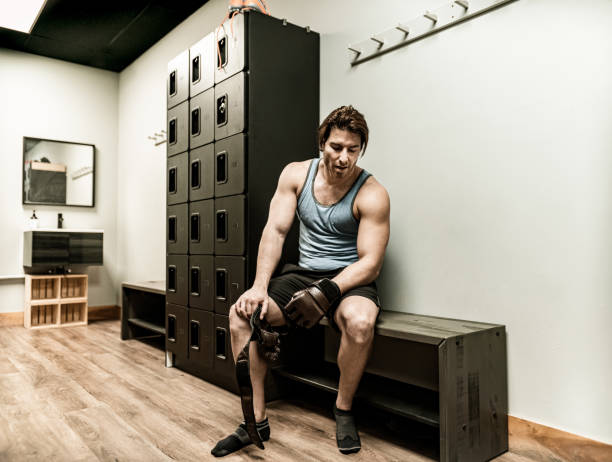 istock Young man taking a break in the Gym locker room 1354079946