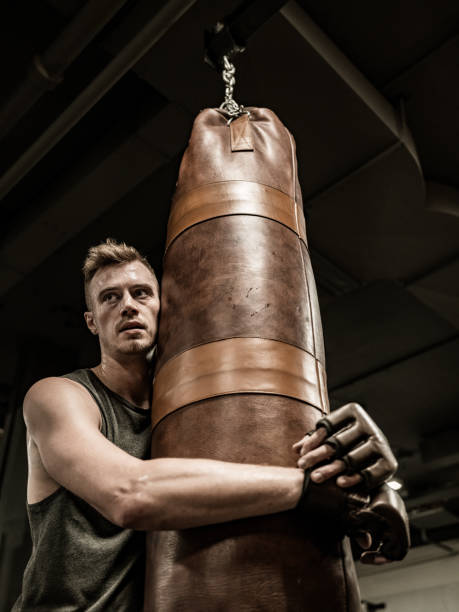 istock Young Man boxing in the Gym 1354080297