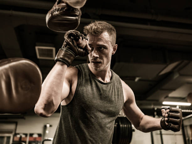 istock Two Young Men boxing in the Gym 1354080359