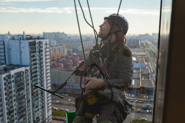 istock Young industrial climber view through glass 1354081600