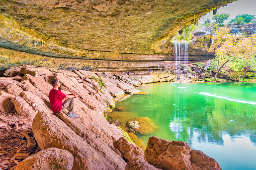 Hiker enjoys view at Hamilton Pool and Waterfall near Austin Texas USA.