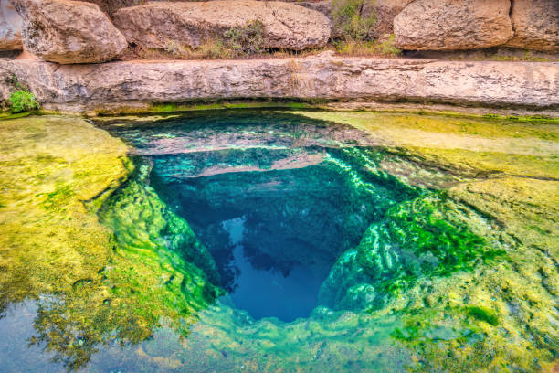 Jacob's Well near Austin Texas USA Jacob's Well, a karstic spring and waterhole in the Texas Hill Country flowing from the bed of Cypress Creek near Austin, Texas, USA. wells stock pictures, royalty-free photos & images