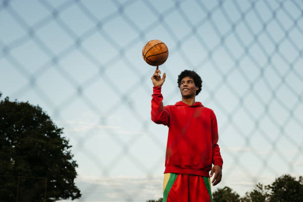 istock Athlete balancing basketball on his finger 1354083576