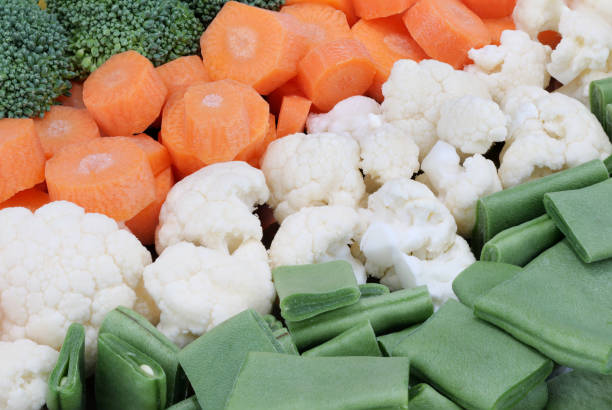 Broccoli, cauliflower, carrots, potatoes – sliced and arranged in rows. Close-up shot. Full frame.