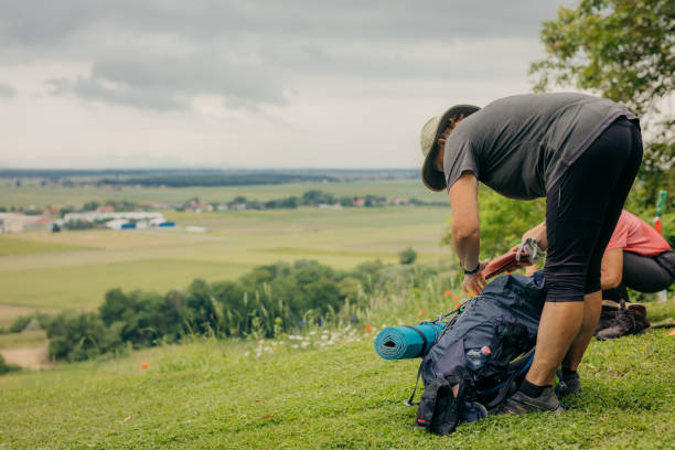 istock Mature female hiker packing backpack on hill 1354085659