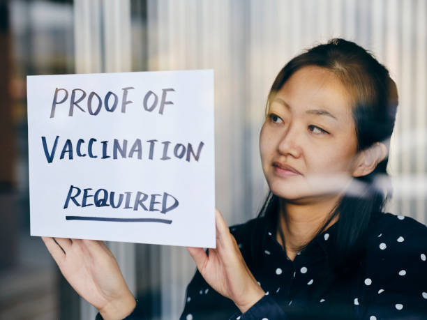 istock Business Owner Wtih Vaccine Mandate Sign 1354085723