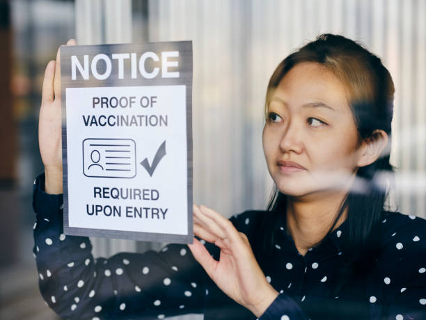 istock Business Owner Wtih Vaccine Mandate Sign 1354085728
