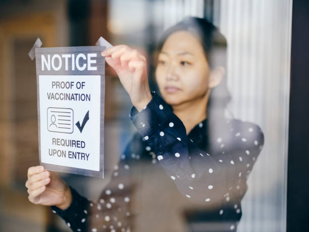 istock Business Owner Wtih Vaccine Mandate Sign 1354085759
