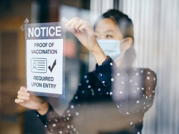 Business Owner Wtih Vaccine Mandate Sign