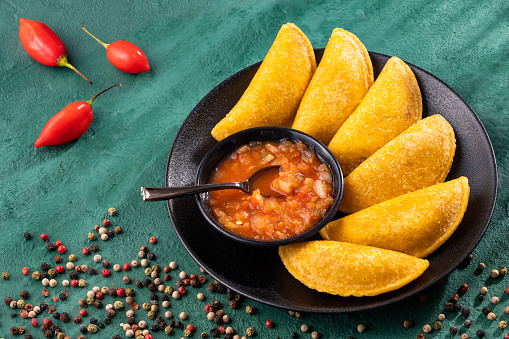 Fried empanadas with spicy sauce - typical Colombian food