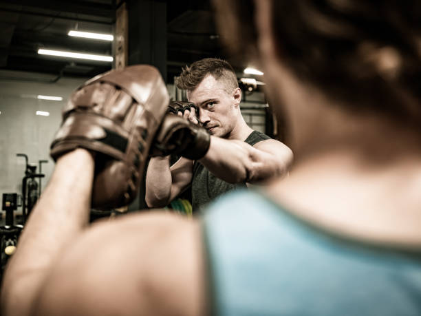 istock Two Young Men boxing in the Gym 1354092189