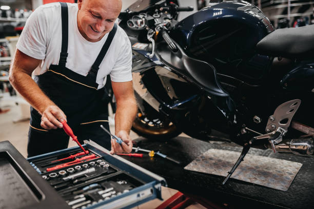 istock A mechanic repairs a motorcycle in a store 1354095260