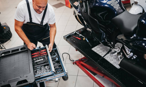 istock A mechanic repairs a motorcycle in a store 1354096753