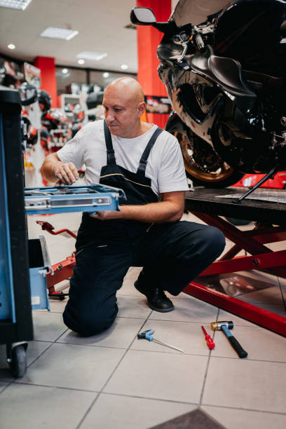 istock Mechanic repairing motorcycle 1354096856