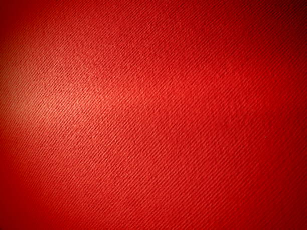 istock Abstract red background with texture. Close-up of paper surface with light and color gradient. Side lighting. Bright crimson backdrop 1354097668