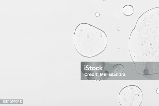 istock Cosmetic product clear drops and space for design on white 1354099045