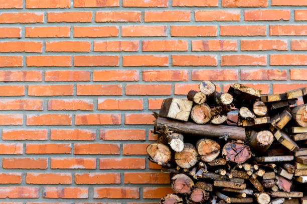 Brick wall sight and pile of firewood background.