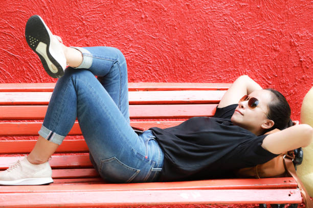 istock Young woman relaxing on a park 1354101641