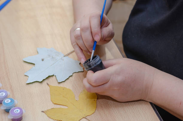 istock The artist draws on dry fallen leaves. 1354105039