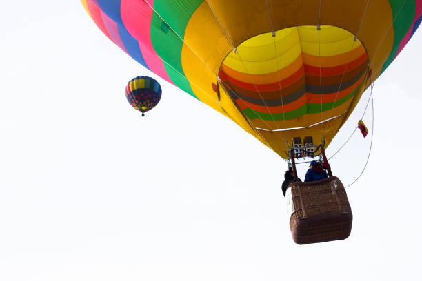 Taos, NM: Two hot air balloons high in the sky at the annual Taos Balloon Fiesta.