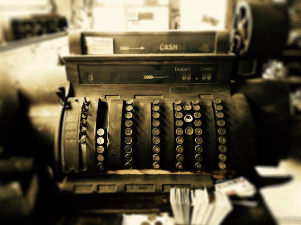 Antique brass cash register. Shot against white background with soft shadow.