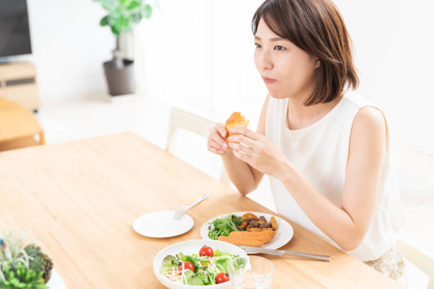 istock attractive asian woman who eats 1354110423