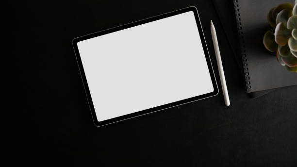 istock Top view of tablet with white screen display on black background. 1354123084