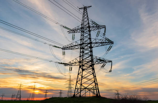 istock power line pylons during sunset with beautiful saturated sky. distribution transmission and consumption of electricity 1354125255