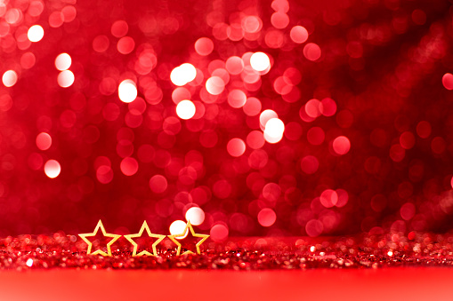Christmas stars on shiny red background