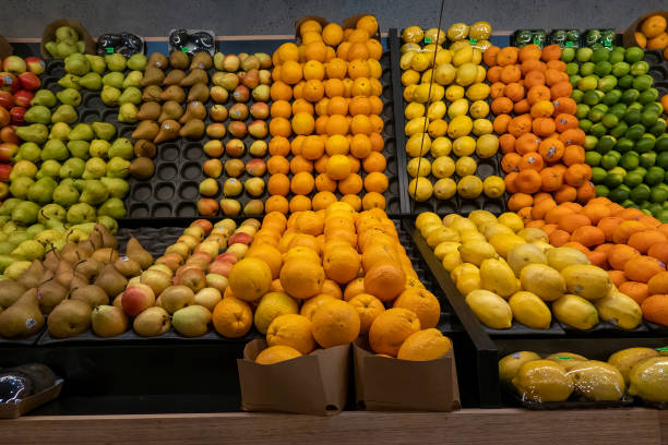 Townsville, Queensland, Australia - November 2021: Delicious juicy fruit on shelves in fruit market with mirror reflections to appear duplicated