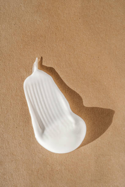 istock The texture of the white cream on a beige background. 1354133652