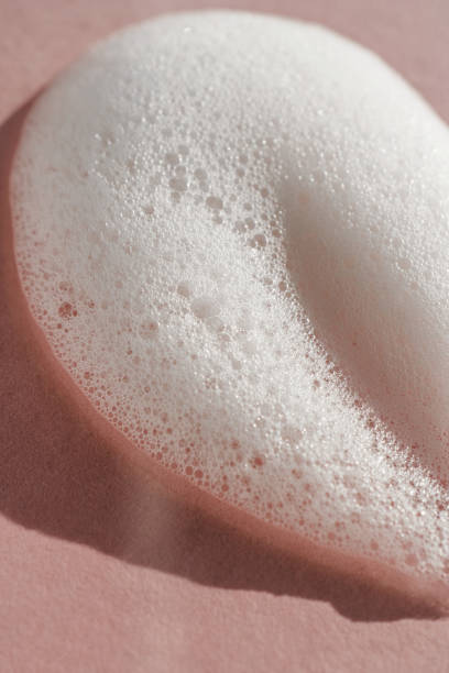 istock Texture of white foam on a pink background. 1354133658