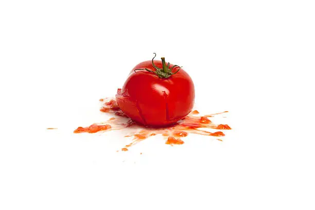 A tomato smashed, crushed, photographed on white, food.