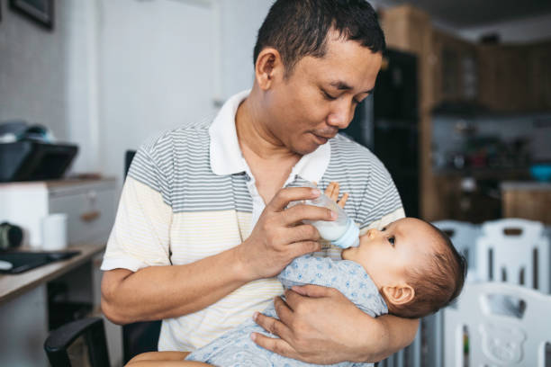 istock father feeding his baby 1354138408