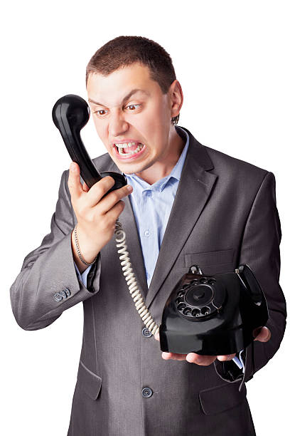 istock Angry businessman screaming in telephone receiver 135414665