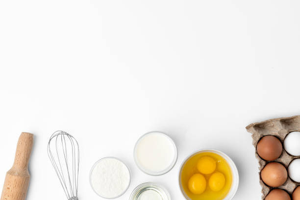 istock Metal whisk and eggs for cooking isolated on white 1354149221