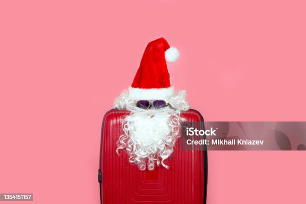 Imitation Of Santa Claus From A Hat Beard And Sunglasses On A Suitcase Stock Photo - Download Image Now