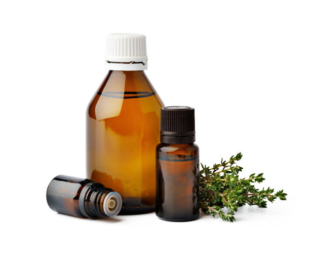 istock Bottle with essential oil and green leaf isolated on white background 1354153906