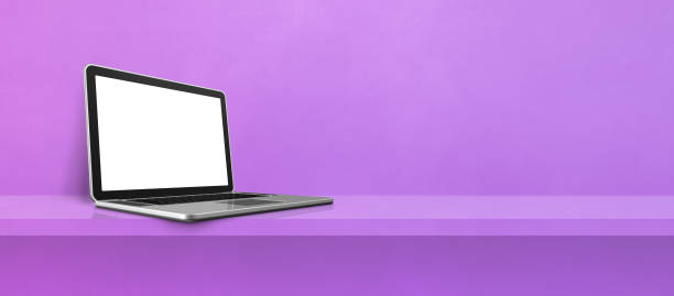 istock Laptop computer on purple shelf background banner 1354155174