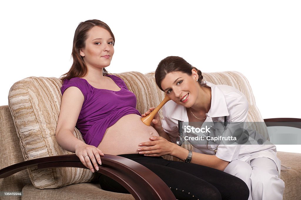 listening a heartbeat by pinard's wood stethoscope Female doctor listen the abdormen of a pregnant woman by pinard's wood stethoscope Pregnant Stock Photo