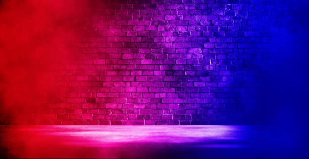 istock Studio dark room with fog or mist and lighting effect red and blue on brick wall and concrete floor grunge texture background. 1354156854