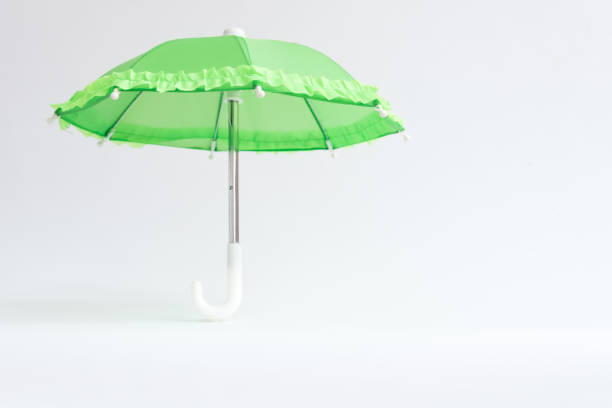 istock Green umbrella on a white background. Protection and safety concept 1354157733
