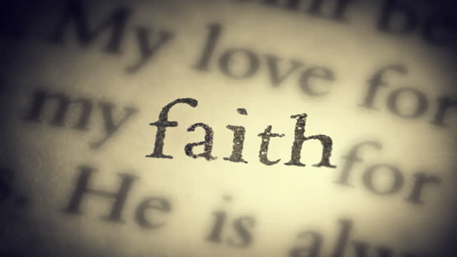 The word faith on an old page in the book is separated from the general text and zooms into the camera. Creative 3D 4k slow motion video animation.