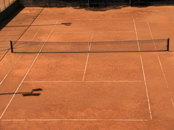 istock Empty tennis clay court with net top view 1354158694