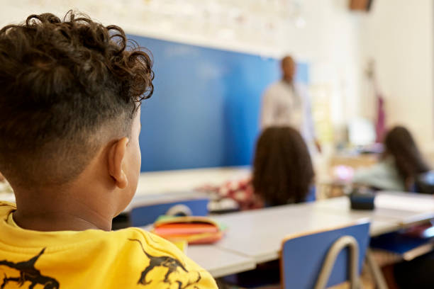 istock Elementary Age Boy Listening to Teacher 1354158696