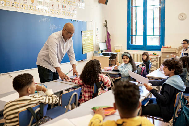 istock Barcelona Teacher Interacting with School Children 1354158698