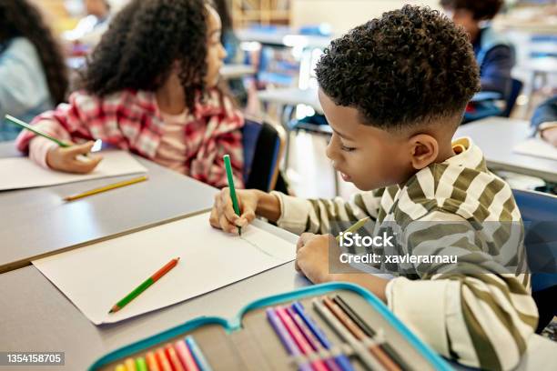 Focused Schoolboy Drawing Picture With Colored Pencils Stock Photo - Download Image Now